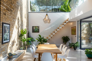 Inspiration for a large contemporary concrete floor and gray floor great room remodel in Other with white walls