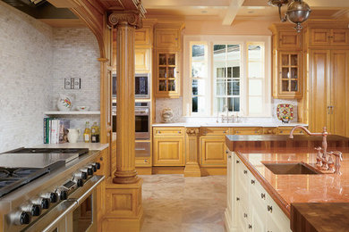 This is an example of an expansive classic l-shaped open plan kitchen in New Orleans with a submerged sink, raised-panel cabinets, medium wood cabinets, marble worktops, white splashback, marble splashback, stainless steel appliances, travertine flooring, multiple islands and beige floors.