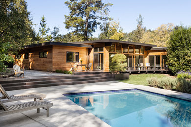 Inspiration for a large contemporary one-story wood and clapboard exterior home remodel in San Francisco with a metal roof and a brown roof