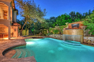 Inspiration for a mid-sized mediterranean backyard rectangular pool in Austin with a water feature and concrete slab.