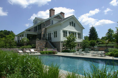 Elegant backyard rectangular lap pool photo in New York