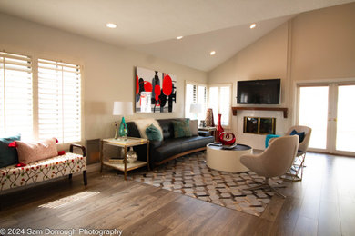 Example of a mid-sized mid-century modern medium tone wood floor and vaulted ceiling living room design with a standard fireplace, a tile fireplace and a wall-mounted tv