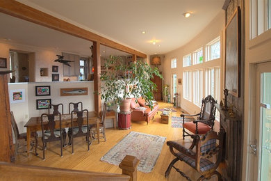 Inspiration for a mid-sized eclectic open concept light wood floor living room remodel in Other with white walls and no fireplace