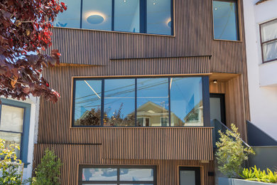 Example of a mid-sized minimalist brown three-story wood exterior home design in Other