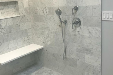 Elegant gray tile and stone tile bathroom photo in New York