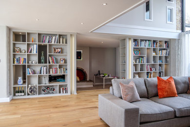 Design ideas for a contemporary home office in Cardiff with medium hardwood flooring.
