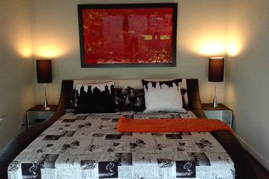 Trendy dark wood floor bedroom photo in Houston with gray walls