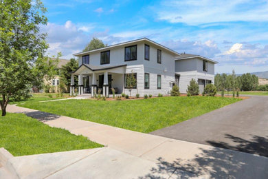 Large trendy white two-story vinyl and clapboard house exterior photo in Denver with a gray roof