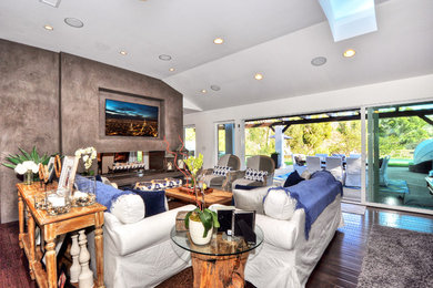 Living room - large transitional formal and open concept dark wood floor and brown floor living room idea in Orange County with a two-sided fireplace, white walls, a plaster fireplace and a wall-mounted tv