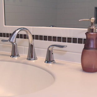 Example of a small transitional master white tile and subway tile vinyl floor bathroom design in Milwaukee with flat-panel cabinets, dark wood cabinets, a two-piece toilet, purple walls, an integrated sink and solid surface countertops