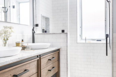 White tile and subway tile cement tile floor, gray floor and double-sink bathroom photo with white walls, a vessel sink, marble countertops, a hinged shower door, white countertops, a niche and a freestanding vanity