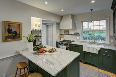Example of a small classic l-shaped light wood floor and brown floor eat-in kitchen design in DC Metro with green cabinets, white backsplash, stainless steel appliances, a peninsula, white countertops, a farmhouse sink, shaker cabinets and quartzite countertops