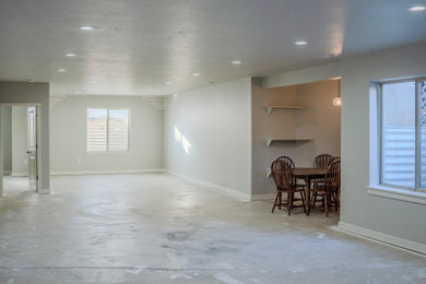 Large arts and crafts underground concrete floor and gray floor basement photo in Salt Lake City with gray walls
