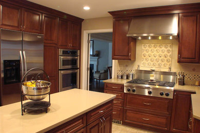 Eat-in kitchen - mid-sized traditional u-shaped ceramic tile and beige floor eat-in kitchen idea in DC Metro with raised-panel cabinets, dark wood cabinets, stainless steel appliances, an undermount sink, an island, quartzite countertops and beige backsplash
