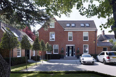 Inspiration for an expansive and brown modern concrete detached house in London with three floors, a half-hip roof and a tiled roof.