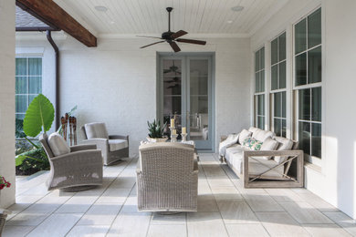 Patio kitchen - transitional backyard stone patio kitchen idea with a roof extension