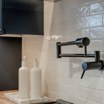 Modern Matte Black Pot Filler on Textured White Subway Tile Backsplash