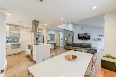 Eat-in kitchen - small modern l-shaped medium tone wood floor eat-in kitchen idea in Atlanta with an undermount sink, flat-panel cabinets, white cabinets, quartz countertops, gray backsplash, glass tile backsplash, stainless steel appliances, an island and white countertops