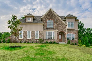 Photo of a mid-sized transitional two-storey beige exterior in Baltimore with mixed siding and a gable roof.