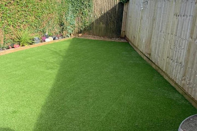 This is an example of a small modern back partial sun garden in West Midlands.