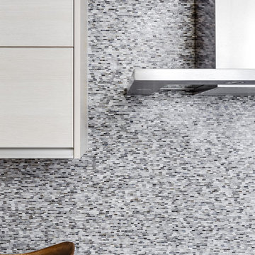 Modern White + Gray Kitchen with Mosaic Tile Backsplash + Stainless Steel Hood