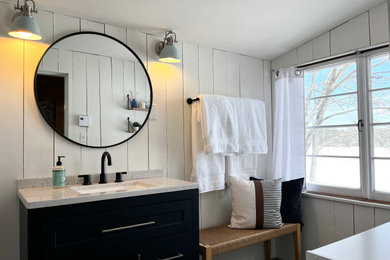 Inspiration for a mid-sized scandinavian single-sink and shiplap wall bathroom remodel in Portland Maine with shaker cabinets, blue cabinets, white walls, an integrated sink, solid surface countertops, multicolored countertops and a freestanding vanity