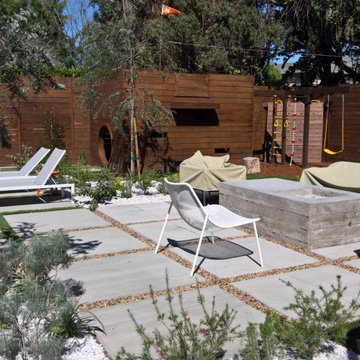 backyard with play structure, fire pit table and new patio
