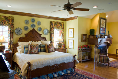 Large elegant master light wood floor bedroom photo in Other with yellow walls, a standard fireplace and a tile fireplace