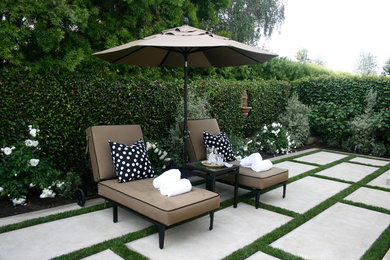 This is an example of a traditional patio in Los Angeles with concrete slab and no cover.