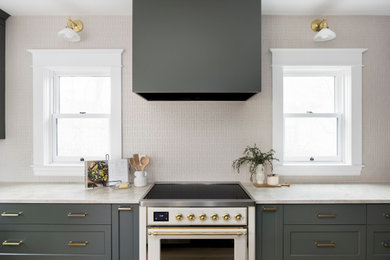 Inspiration for a huge timeless l-shaped light wood floor and brown floor enclosed kitchen remodel in Portland with an undermount sink, shaker cabinets, green cabinets, quartzite countertops, white backsplash, ceramic backsplash, stainless steel appliances, an island and gray countertops