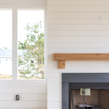 Outdoor Fireplace with Shiplap Surround and Wood Mantel