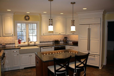 Mid-sized elegant u-shaped ceramic tile and brown floor eat-in kitchen photo in Chicago with a farmhouse sink, glass-front cabinets, white cabinets, granite countertops, white backsplash, subway tile backsplash, stainless steel appliances and an island