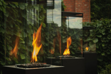 Inspiration for a medium sized contemporary back formal garden in London with a fire feature.