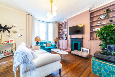 Medium sized victorian living room in London with pink walls, dark hardwood flooring and brown floors.