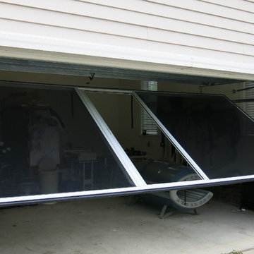 Screen is easily swung down in place of garage door when needed