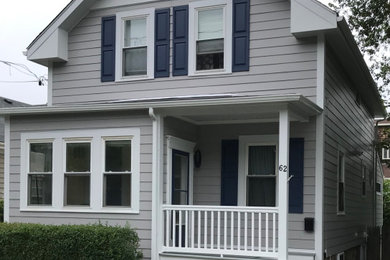 Example of a mid-sized classic gray two-story concrete fiberboard exterior home design in Providence with a shingle roof