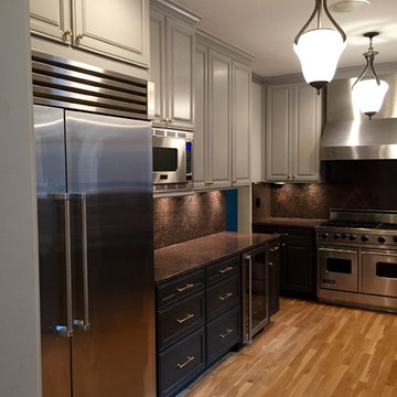 Grey Cabinets upper and dark cabinets lower.