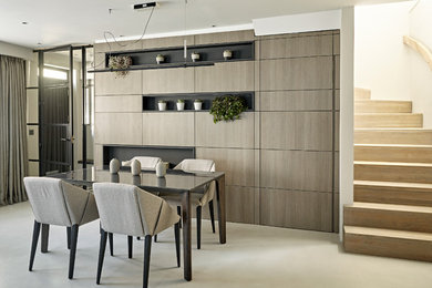 This is an example of a mid-sized contemporary open plan dining in London with beige floor.