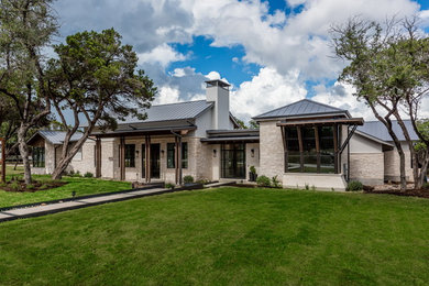 Example of a transitional white one-story stone exterior home design in Austin
