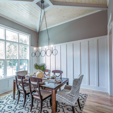 The dining room receives natural light from the large window unit