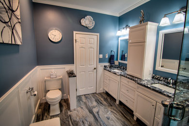 Example of a mid-sized master blue tile and porcelain tile porcelain tile, blue floor, double-sink and vaulted ceiling bathroom design in Philadelphia with flat-panel cabinets, white cabinets, a two-piece toilet, blue walls, an undermount sink, quartz countertops, a hinged shower door, blue countertops and a built-in vanity