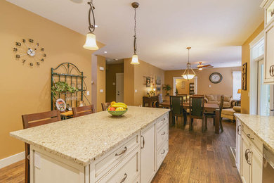 Inspiration for a mid-sized timeless l-shaped dark wood floor eat-in kitchen remodel in Vancouver with an undermount sink, shaker cabinets, white cabinets, quartz countertops, ceramic backsplash, stainless steel appliances and an island
