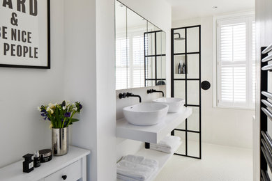 Mid-sized contemporary 3/4 bathroom in London with open cabinets, white cabinets, an open shower, beige tile, porcelain tile, white walls, porcelain floors, a vessel sink, beige floor and white benchtops.