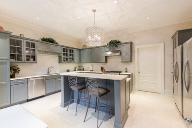 Mid-sized transitional u-shaped beige floor enclosed kitchen photo in Atlanta with shaker cabinets, gray cabinets, stainless steel appliances and an island