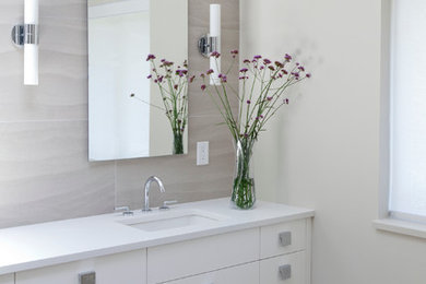 Inspiration for a large contemporary master beige tile and porcelain tile porcelain tile doorless shower remodel in Vancouver with flat-panel cabinets, white cabinets, beige walls and quartz countertops