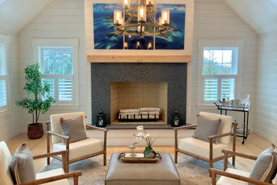 Example of a large beach style open concept light wood floor, shiplap ceiling and shiplap wall living room design in Boston with white walls, a standard fireplace and a concrete fireplace