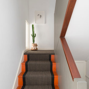 Design ideas for a contemporary painted wood l-shaped staircase in London with painted wood risers.