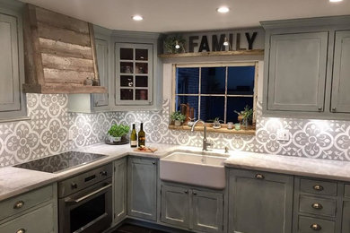 Design ideas for a mid-sized country l-shaped separate kitchen in Miami with a farmhouse sink, beaded inset cabinets, grey cabinets, marble benchtops, grey splashback, cement tile splashback, stainless steel appliances, ceramic floors, no island and brown floor.