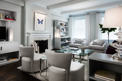 Example of a mid-sized trendy enclosed dark wood floor and brown floor living room design in New York with gray walls, a standard fireplace, a tv stand and a tile fireplace