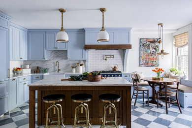 Example of a mid-sized classic l-shaped marble floor enclosed kitchen design in Boston with a farmhouse sink, recessed-panel cabinets, blue cabinets, marble countertops, subway tile backsplash and an island